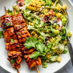 BBQ Chicken Skewer Salad featuring juicy chicken, colorful greens, and BBQ sauce.