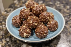 Homemade peanut butter balls on a plate, a delicious snack recipe.
