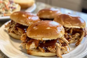Slow-Cooker BBQ Shredded Chicken Sandwiches served with coleslaw