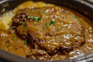Delicious Crock Pot hamburger steaks simmering in savory gravy