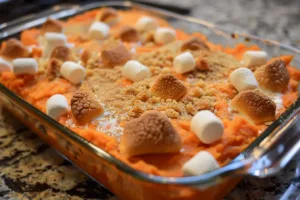 Delicious sweet potato casserole topped with marshmallows and pecans