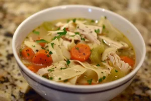 Bowl of leftover turkey chicken soup with vegetables