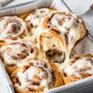 Fluffy Christmas Cinnamon Rolls with caramel cream cheese icing ready for the holidays